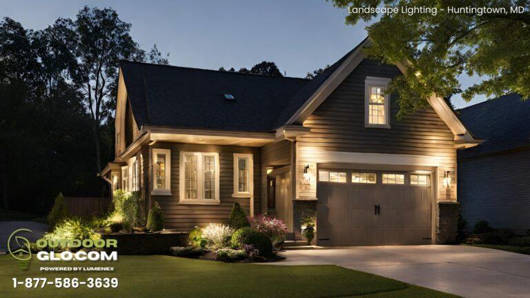 White home with driveway and outdoor lighting